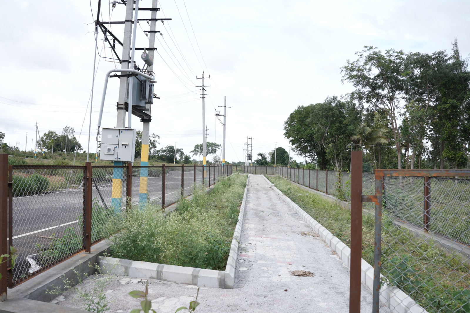 Dhanya's Aashraya residential plot road view Tallur Circle Mysore